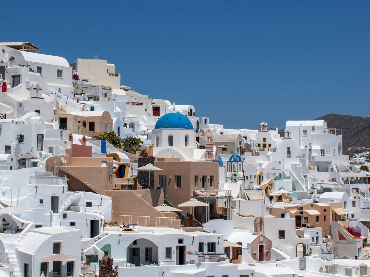 Whitewashed buildings and blue domes in Fira, Santorini, Greece
