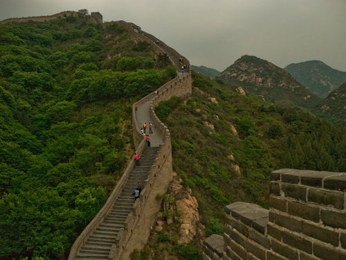 Great Wall of China through green mountains