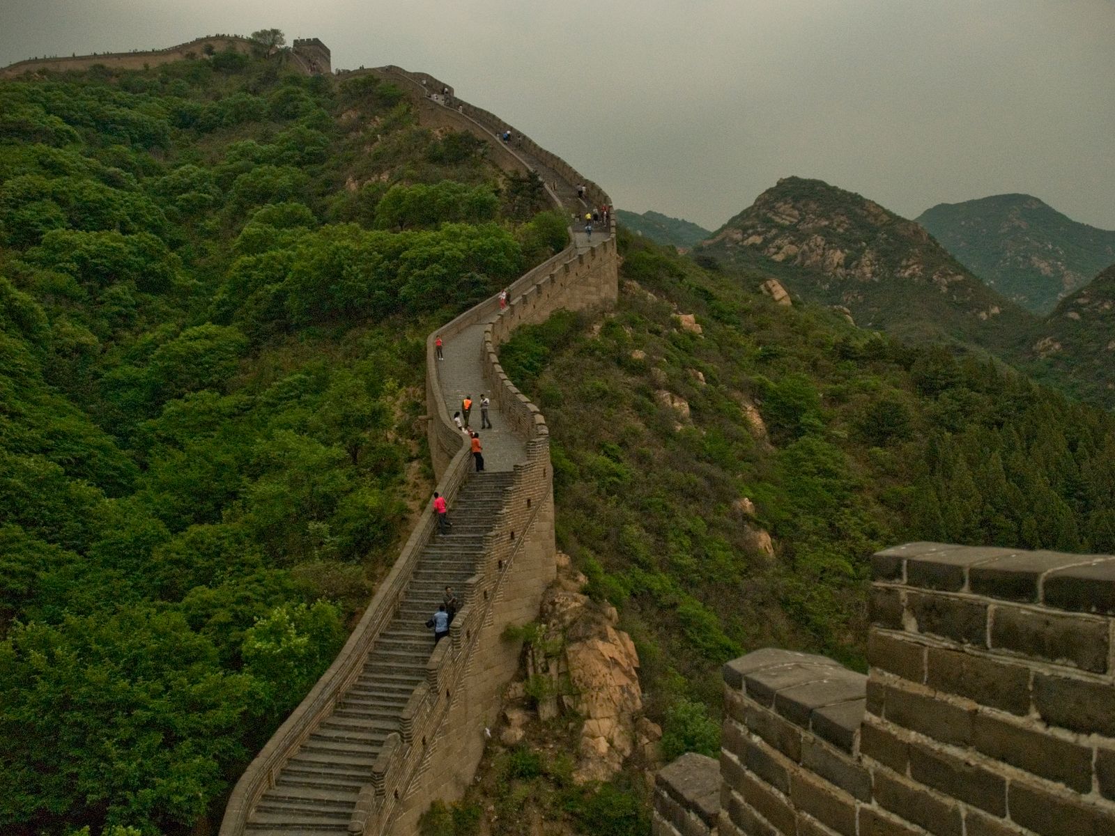 Great Wall of China through green mountains