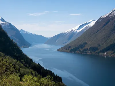 Fjord between snow-capped mountains near Sogndal, Norway