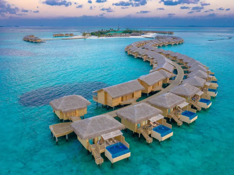 Overwater villas above a turquoise lagoon in the Maldives