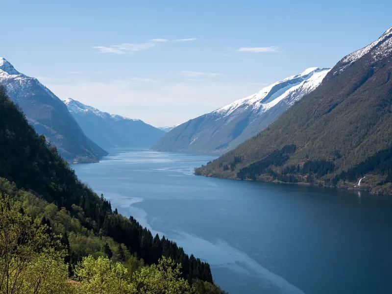 Fjord between snow-capped mountains near Sogndal, Norway